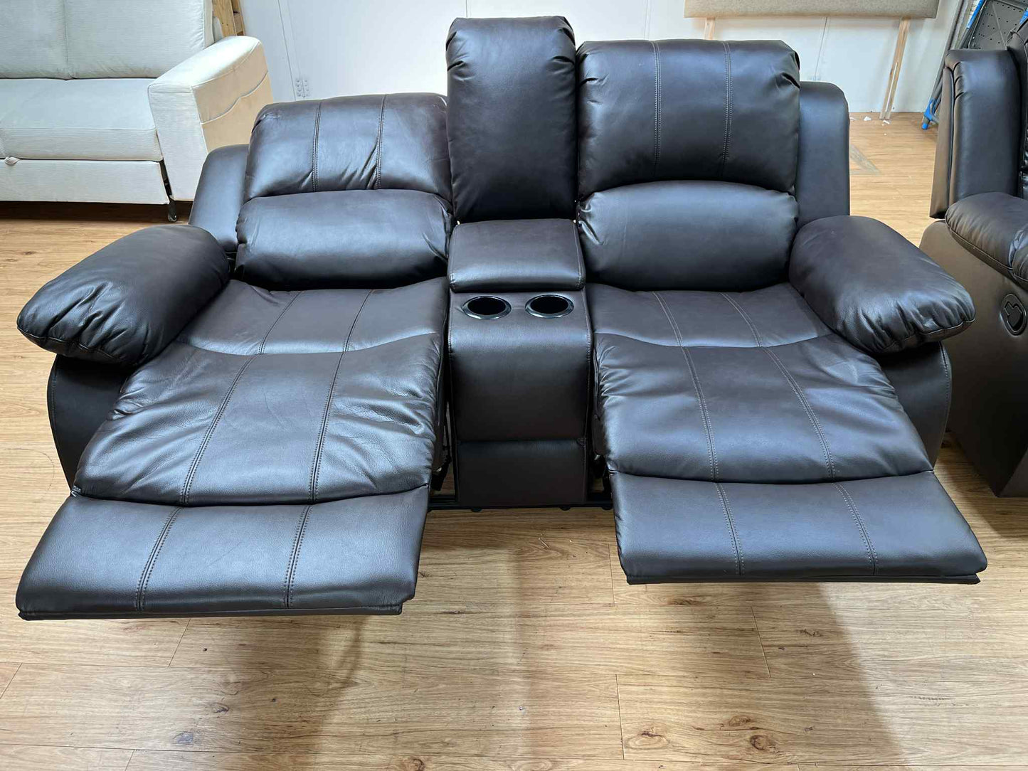 Haden Brown Faux Leather 2 Seater Manual Reclining Sofa with Storage Arm Cup Holders